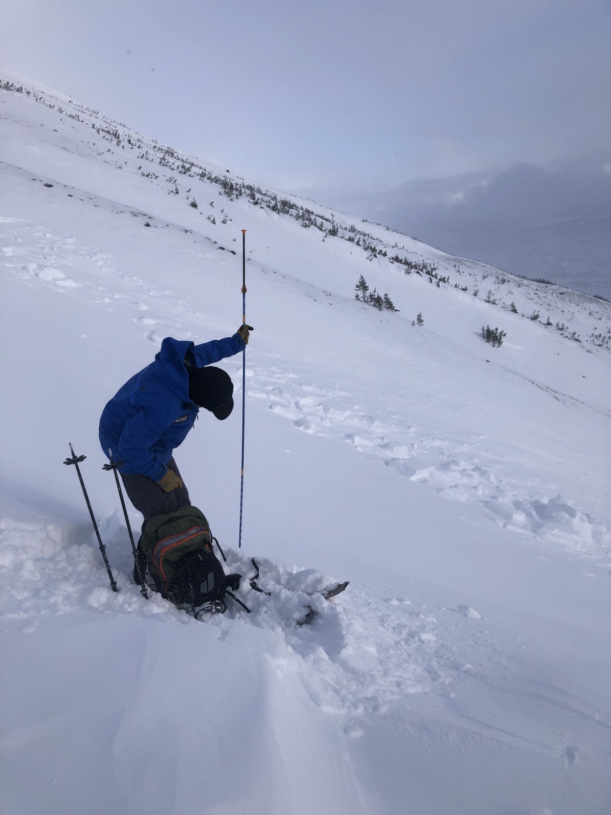 Probing the depth of newly wind-deposited storm snow adjacent to the Sz 2 slide on the south end of Fraser Chutes (sled chutes)
