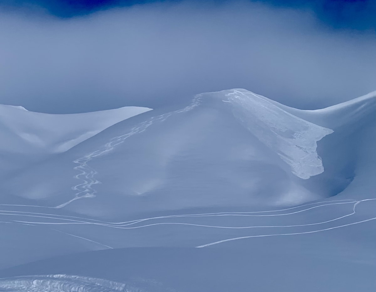 Snowboard tracks visible on the left with remotely trigger slab avalanche on the right.
