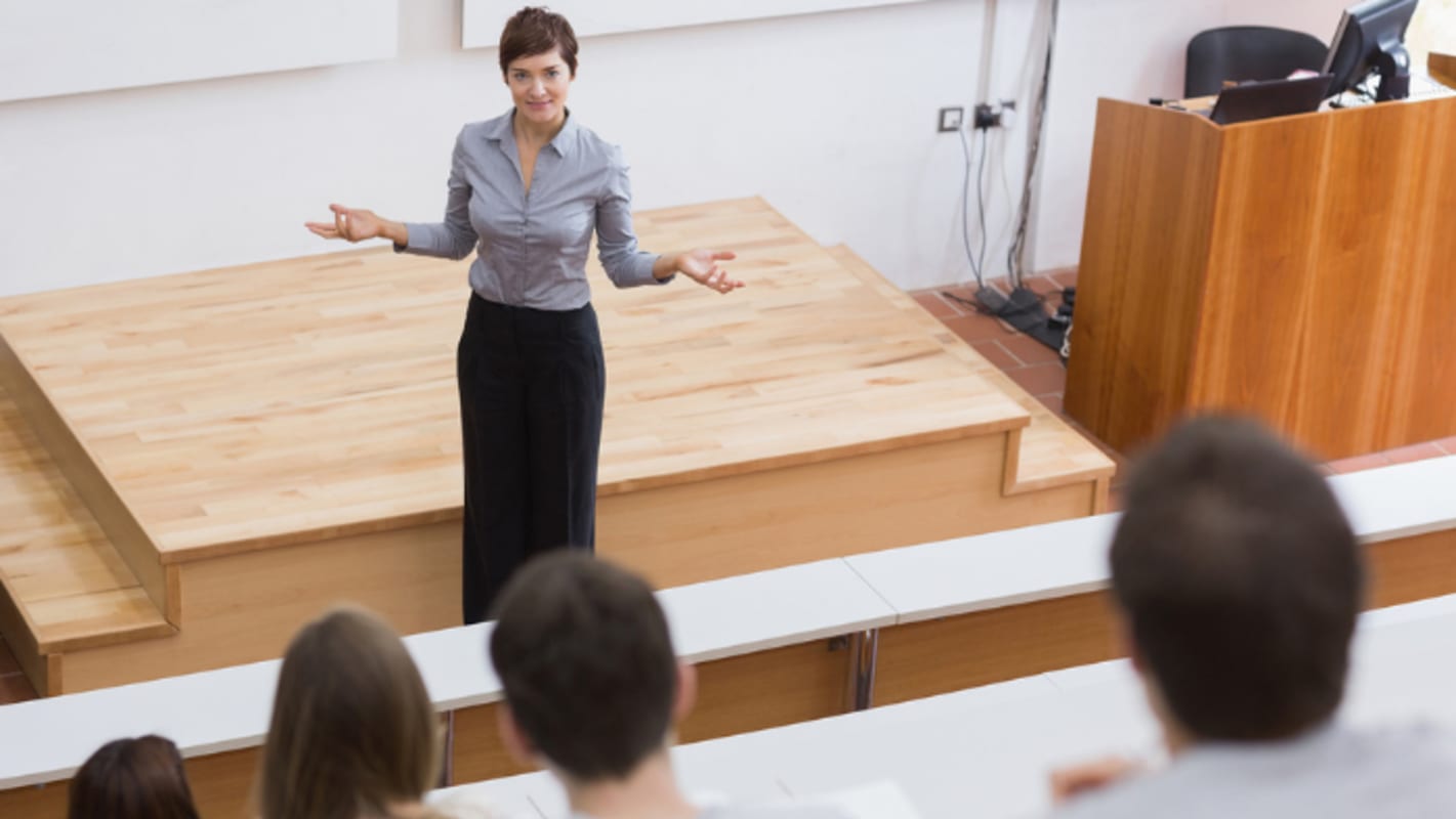 teacher-in-front-of-a-projection-screen-in-classroom
