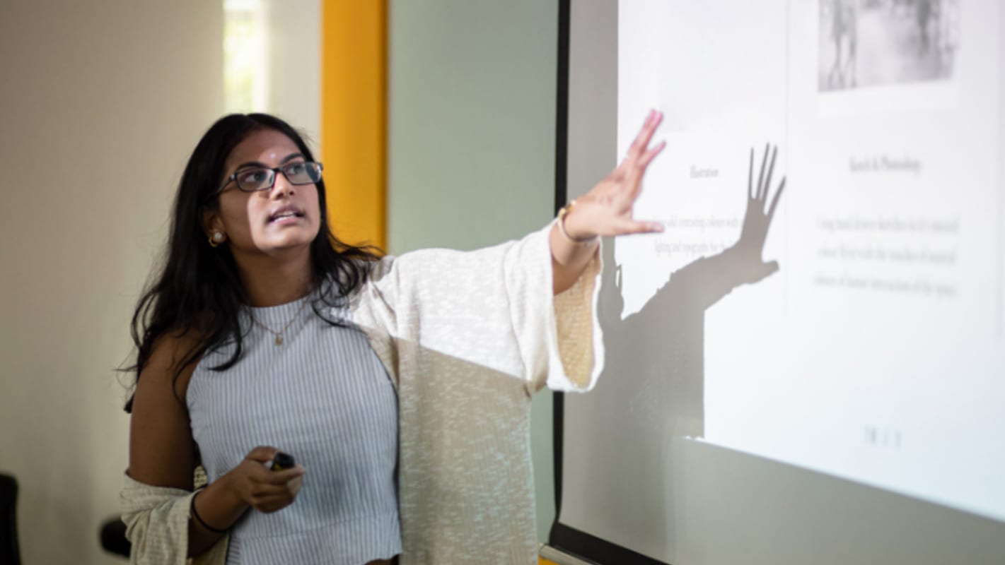 teacher-in-front-of-a-projection-screen-in-classroom