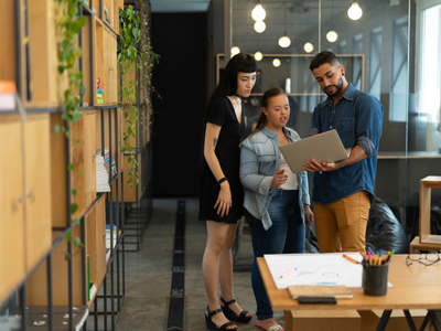 Three team members in a small office