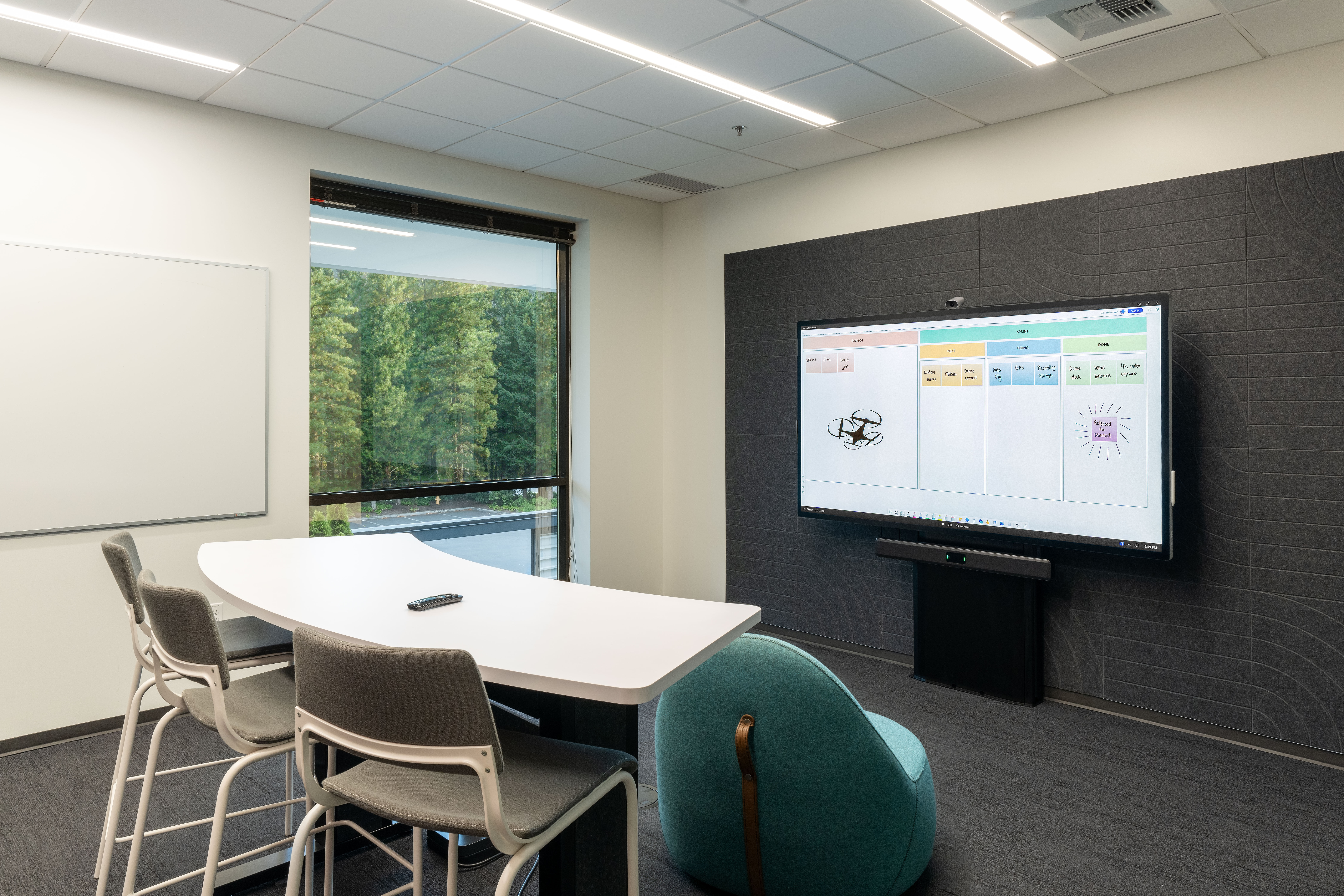 Overview of the Microsoft Hub Surface room with arc table and electric height adjust mount.