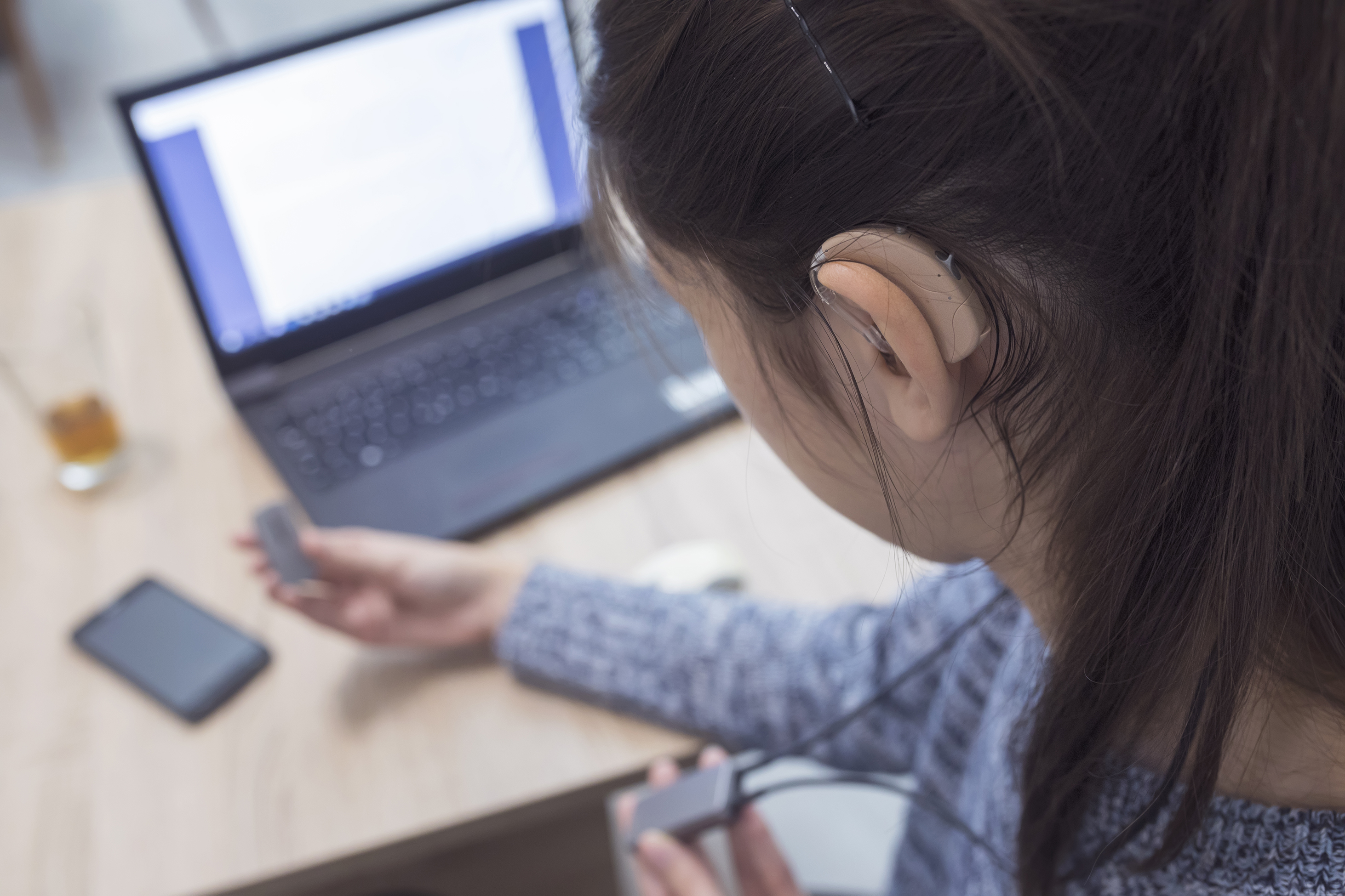 woman with hearing aid using a neck loop