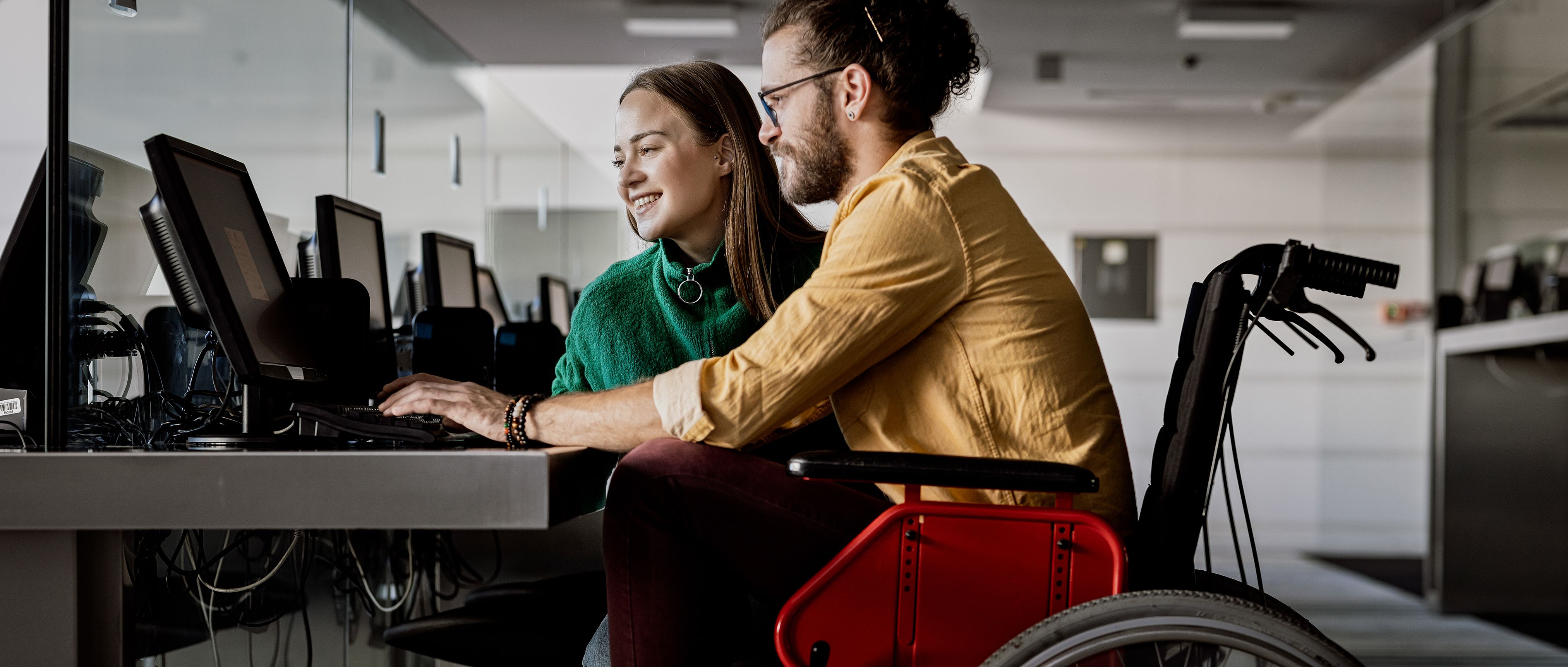 Man in wheelchair in college computer room.