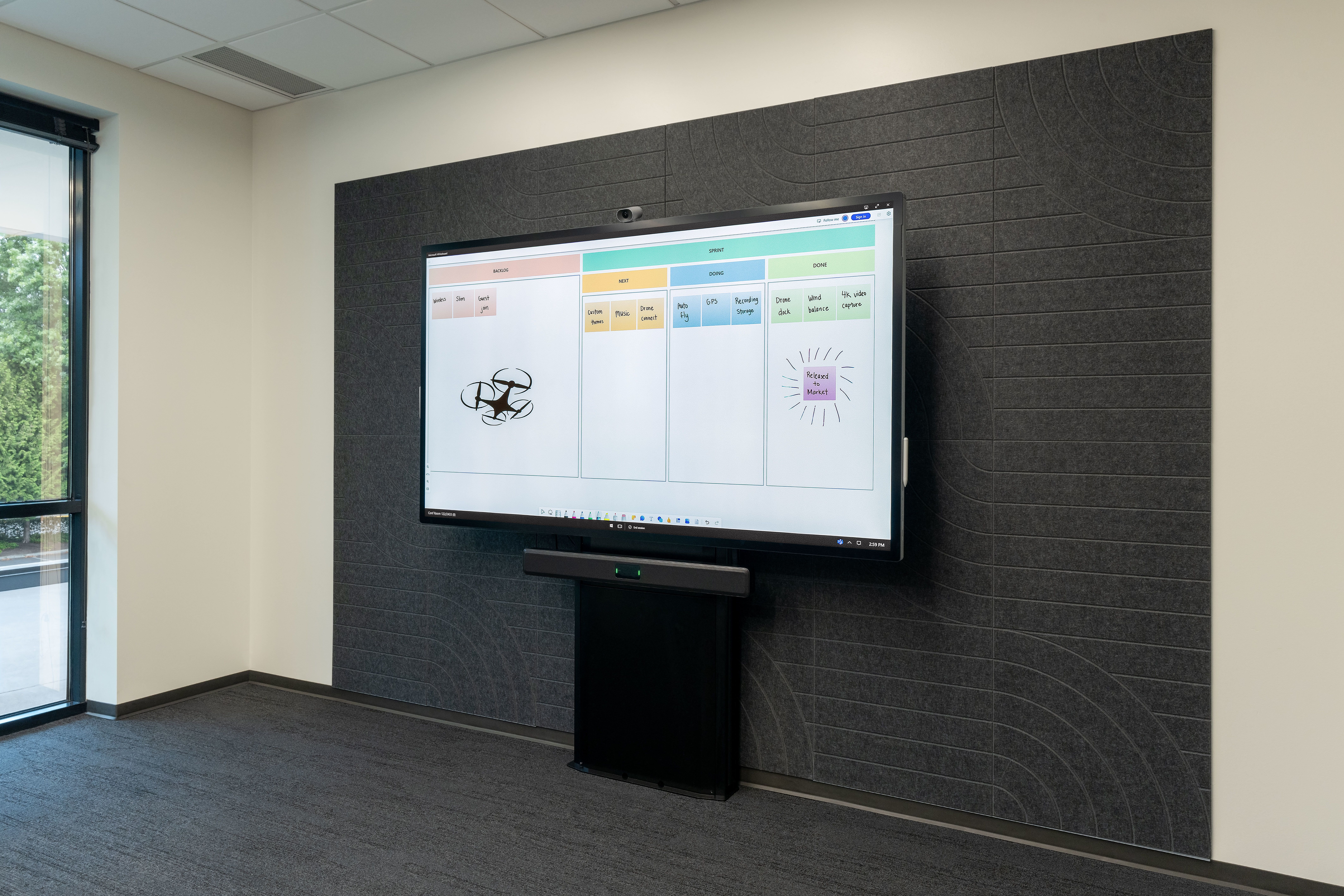 Electric height adjust mount with display against the wall.