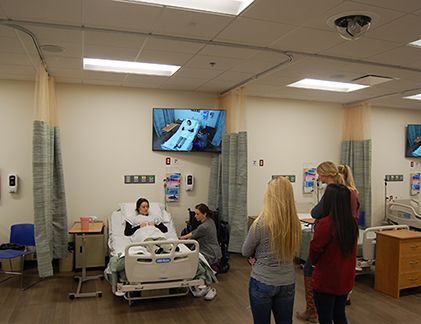 Medical demonstration with students in classroom.