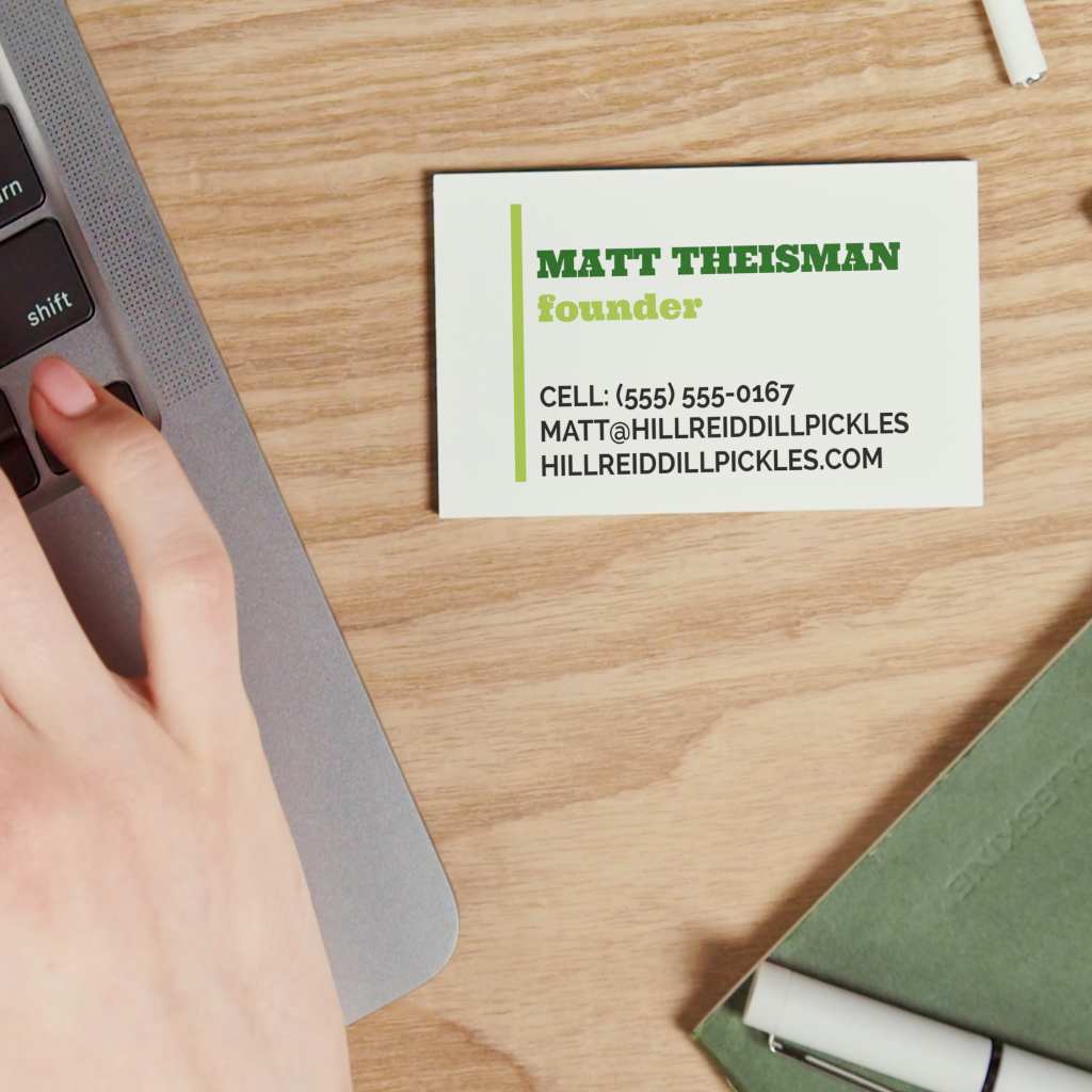 Business card on a desk next to a laptop and notebook, illustrating how business cards support low-pressure follow-up after events.