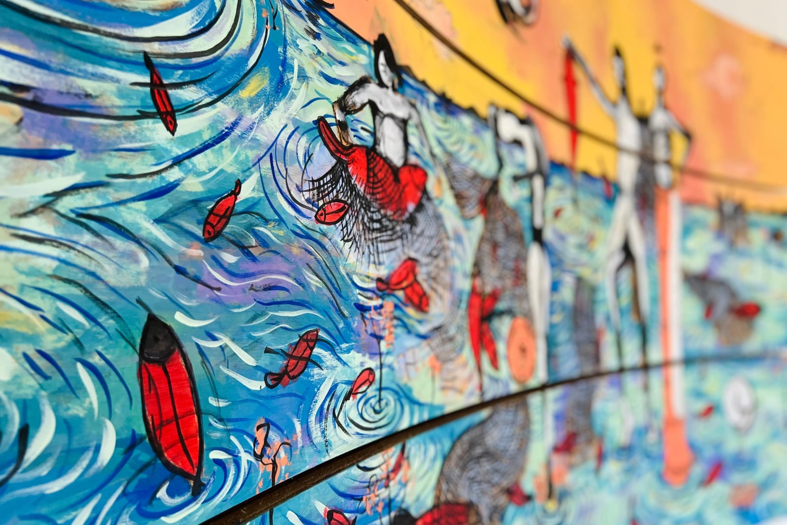 Mural de pescadores y peces en tonos azules