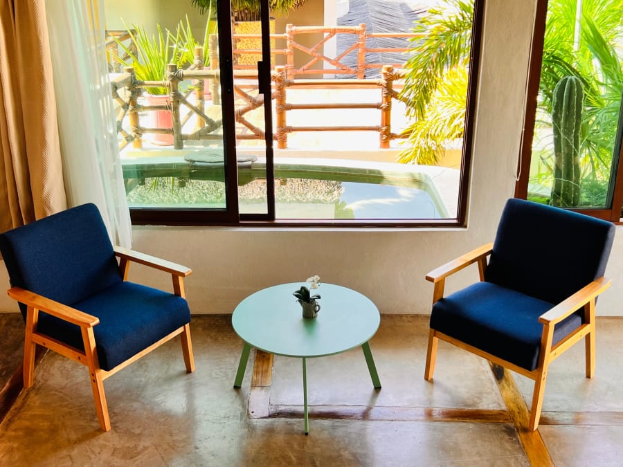 Sillones azules y mesa frente al ventanal