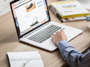 Person on laptop learning how to use link builder API to save time on bulk building Awin tracking links