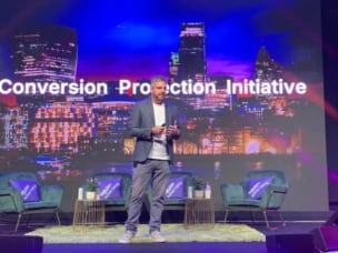  Awin's CEO, Adam Ross, on stage presenting the Conversion Protection Initiative at PI Live Europe.