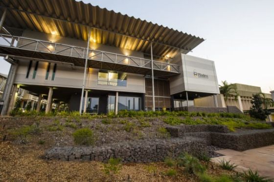 Approached from the Menzies School of Health Research, the over-sailing roof becomes the prominent feature of the building.