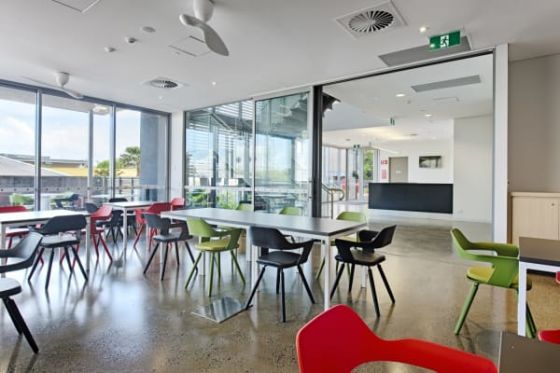 Exposed concrete floors and low-turbulence ceiling fans create a sense of natural cooling