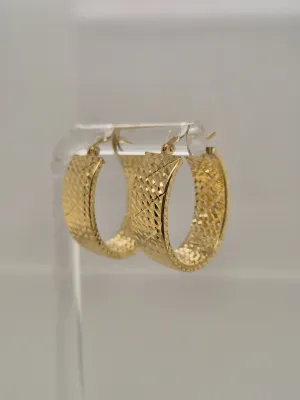 14 KT yellow gold oval hoops with a diamond cut design