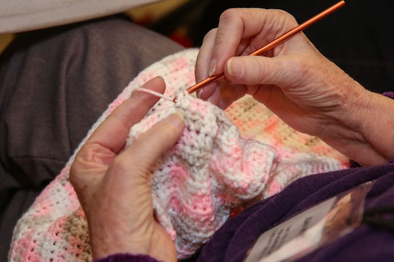 women sewing baby clothes