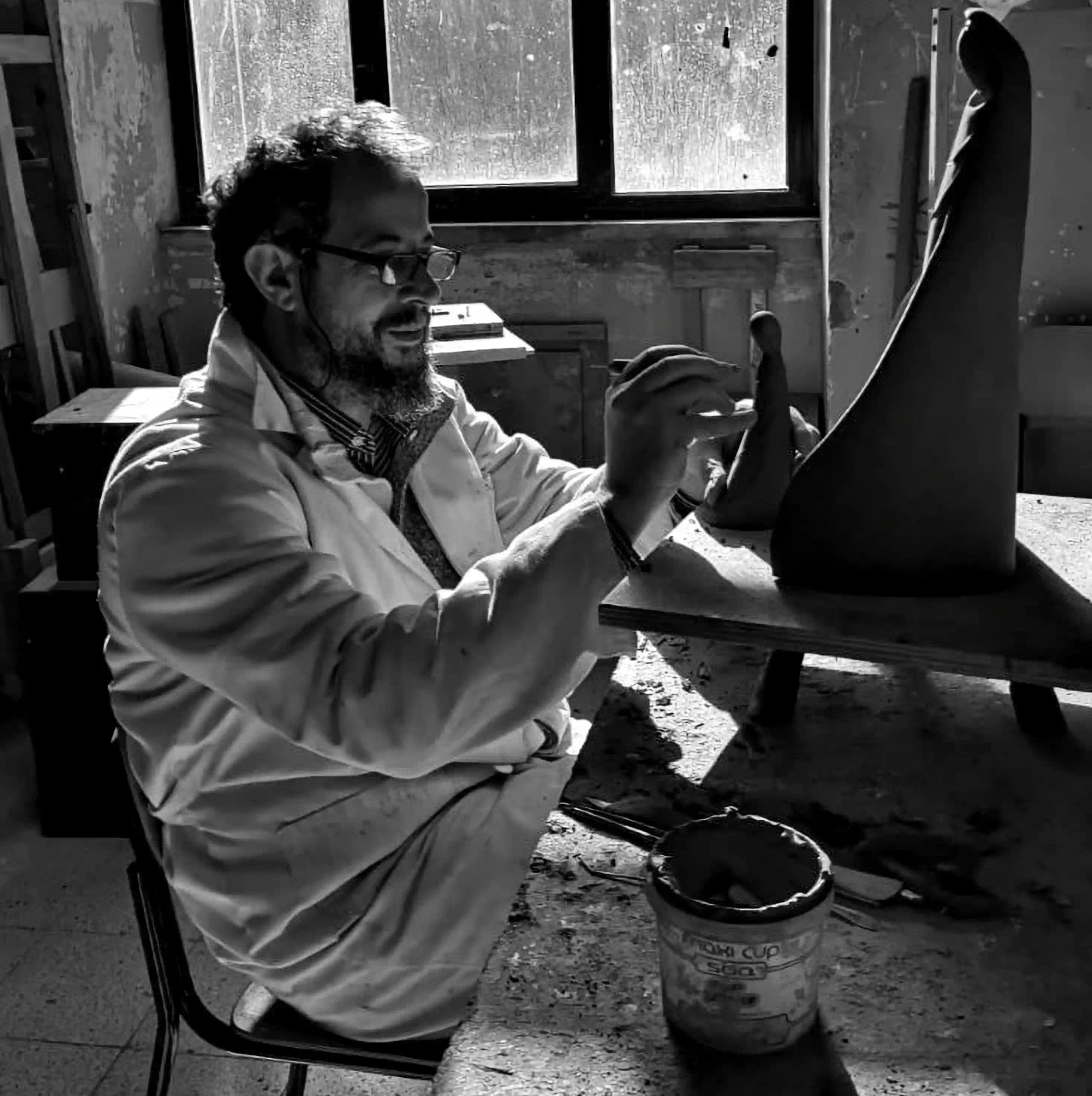 Maestro Filadelfio Todaro modeling a dynamic terracotta animal sculpture in his Caronia studio
