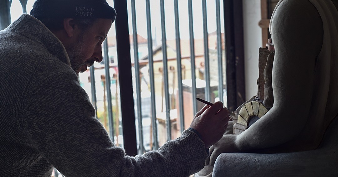 Maestro Filadelfio Todaro applying fine detail work to a ceramic figure in his Caronia studio