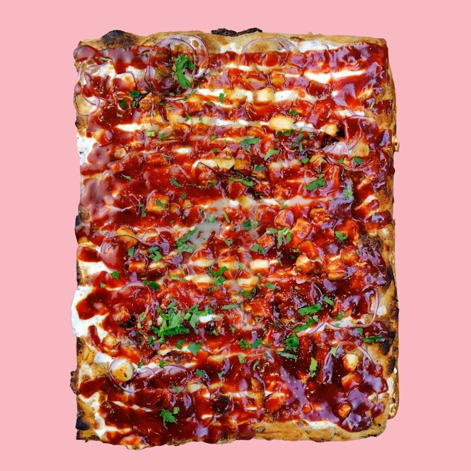 Chicken BBQ Roman-style pizza with aged mozzarella cheese, red onion, chicken cutlet, BBQ sauce at Pizza Collective, Upper West Side NYC