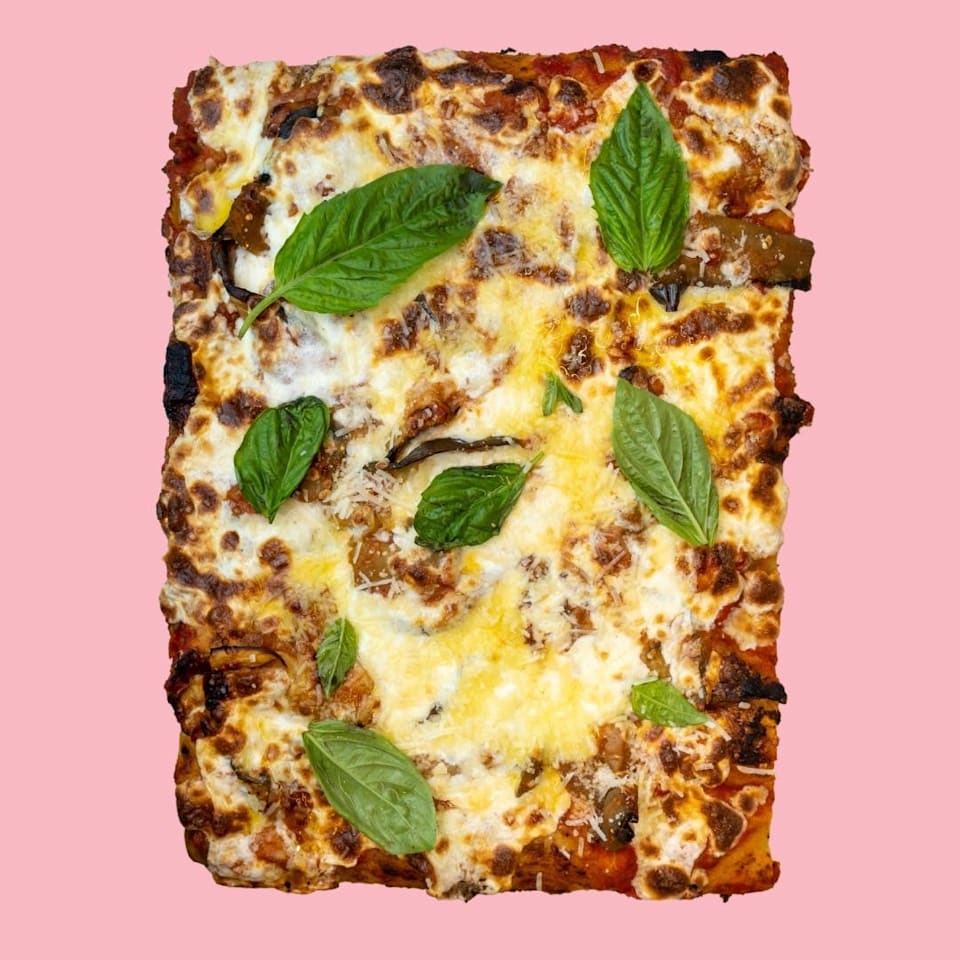 Parmigiana Roman-style pizza with fresh organic tomato sauce, aged mozzarella cheese, eggplant, parmigiana cheese, basil, organic eggs at Pizza Collective, Upper West Side NYC