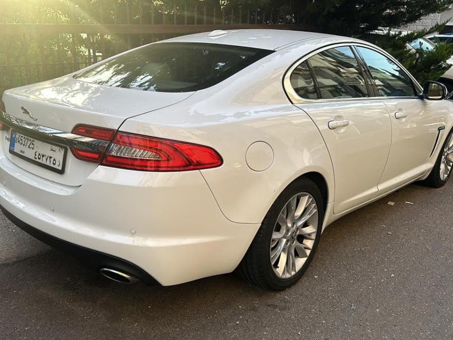 Rear three-quarter view of the white Jaguar XF