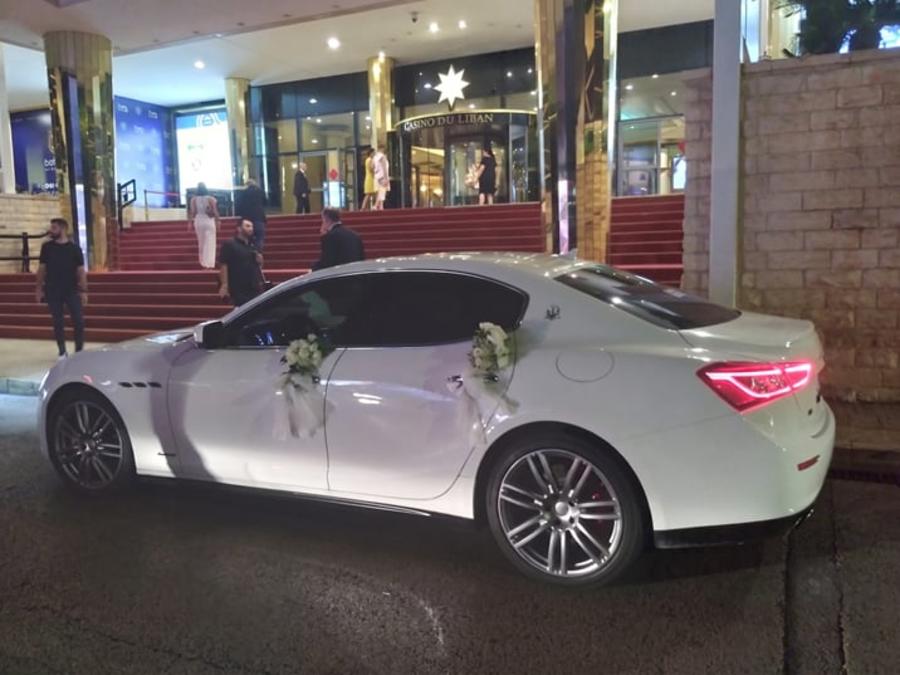 White Maserati Ghibli with flowers on the doors at Casino du Liban