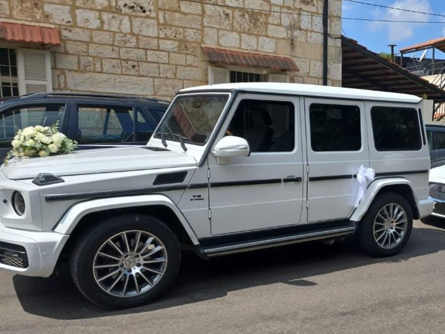 White G-Class decorated with flowers and ribbons in an old Jounieh street