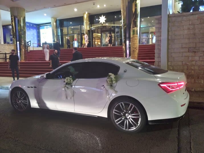White Maserati Ghibli with flowers on the doors at Casino du Liban