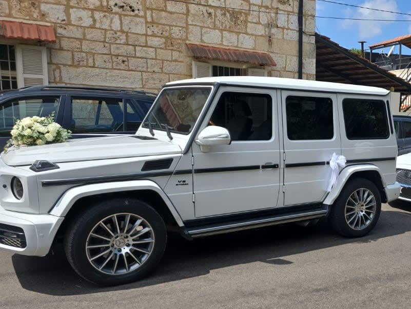 White G-Class decorated with flowers and ribbons in an old Jounieh street