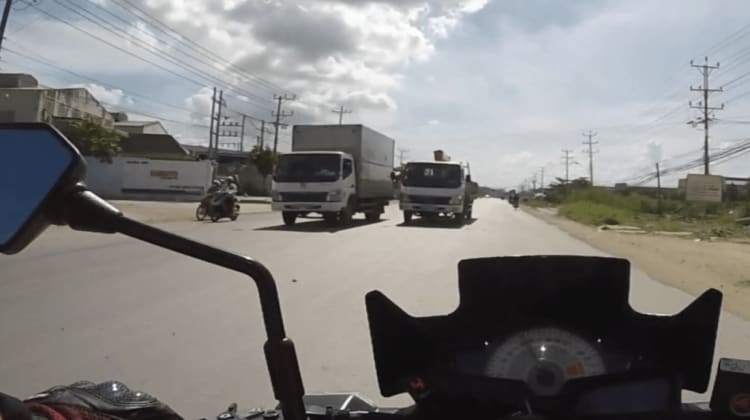 Dangerous track passing another truck in Long An Province, Vietnam