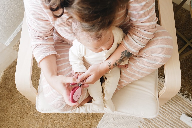 Premium Photo | Mother cutting baby nails. newborn hygiene concept.