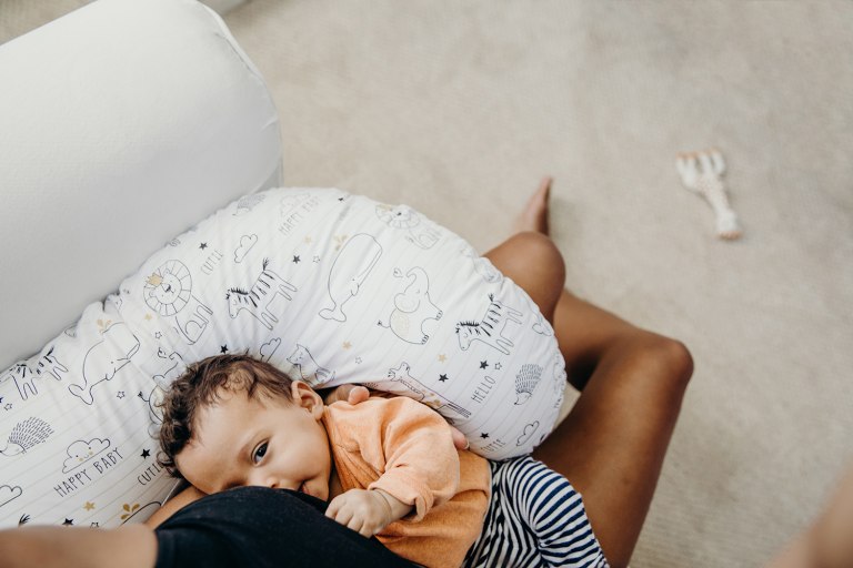 baby sleeping on a boppy