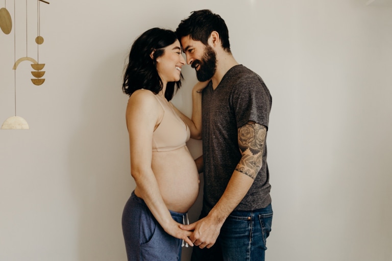 Young pregnant woman holding baby bottle hi-res stock photography