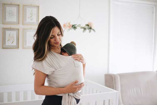parent holding baby in wrap