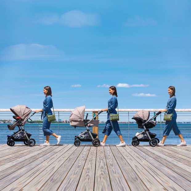 parent pushing travel system