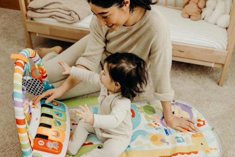 parent and baby with toy