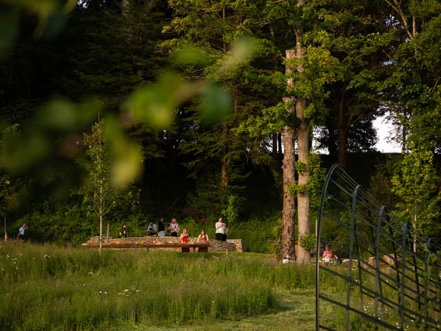 Guests helping themselves to barbecue fare on a sunny evening in the gardens