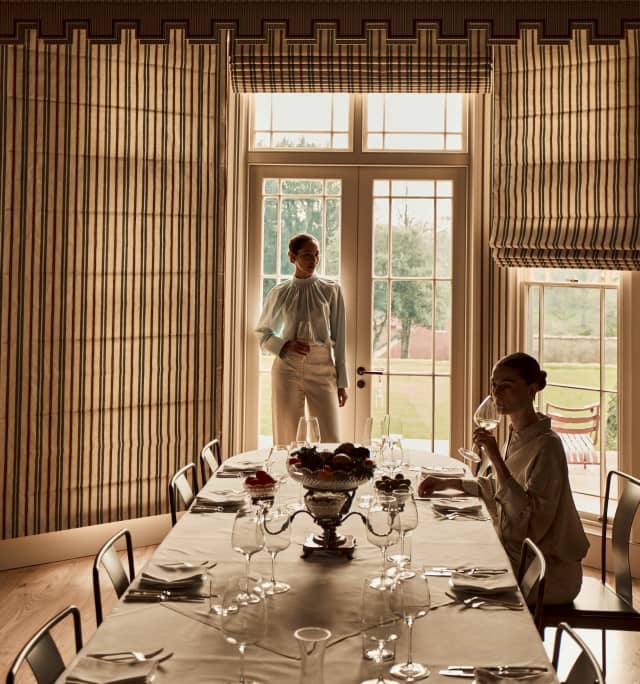Two woman sit down for a refined lunch in the dining room
