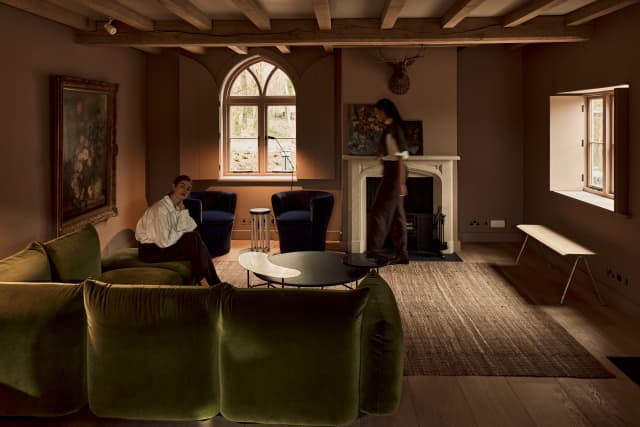 Two women relax in the lviing room of the Cottage in the Wall