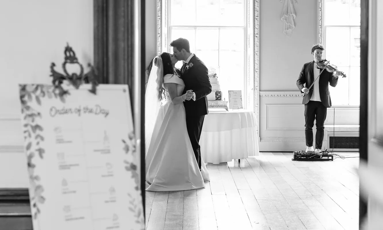 A couple framed in a ballroom doorway