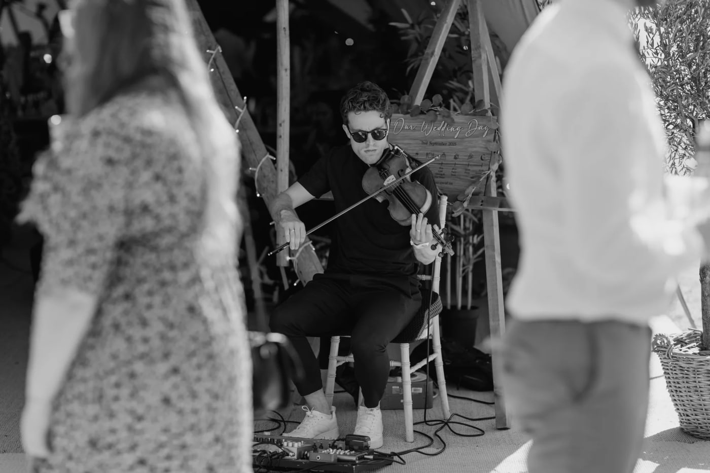 Wedding guests in a marquee watching Joel Grainger