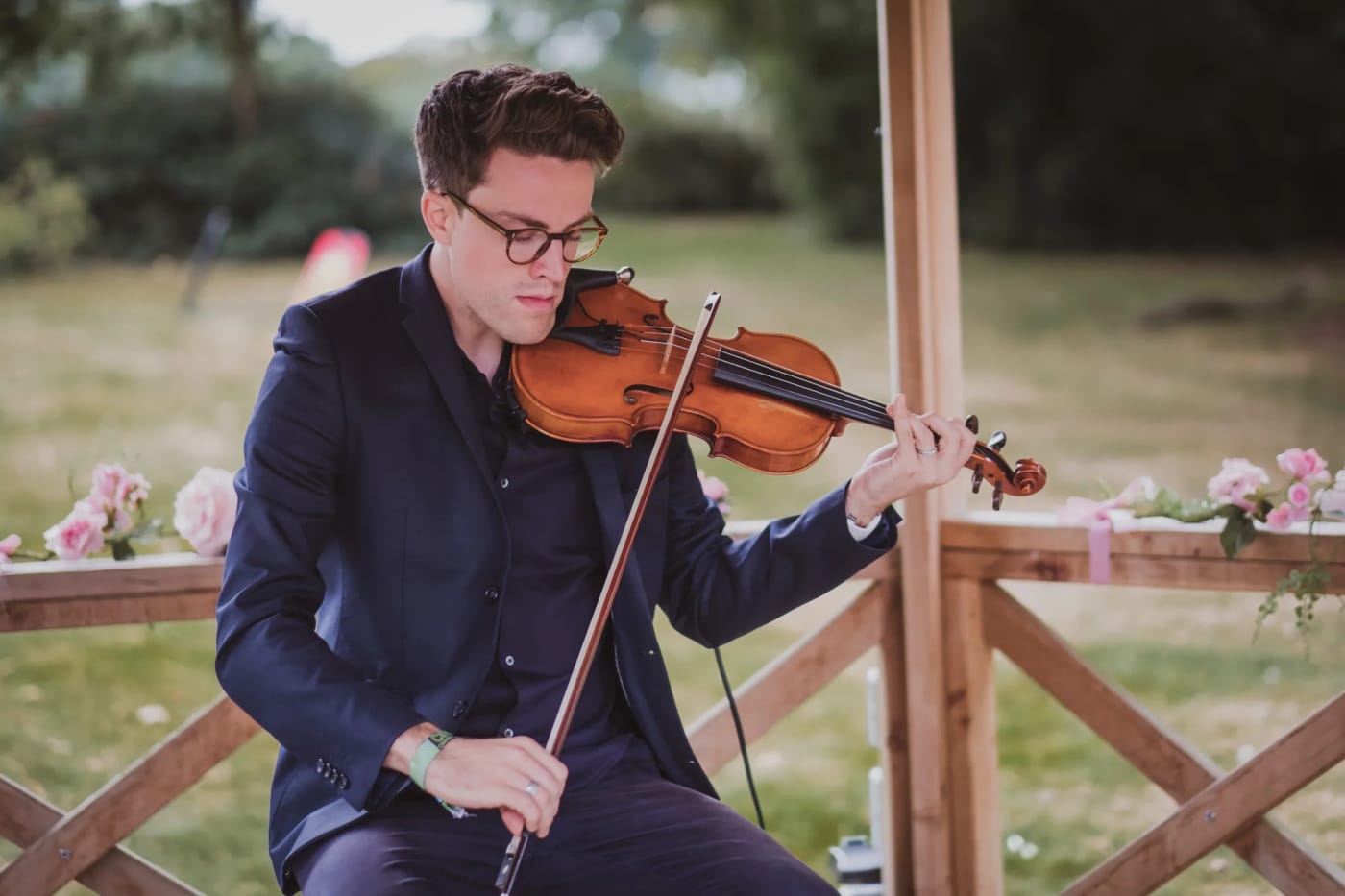 Joel Grainger playing under a pergola at a Wedding ceremony