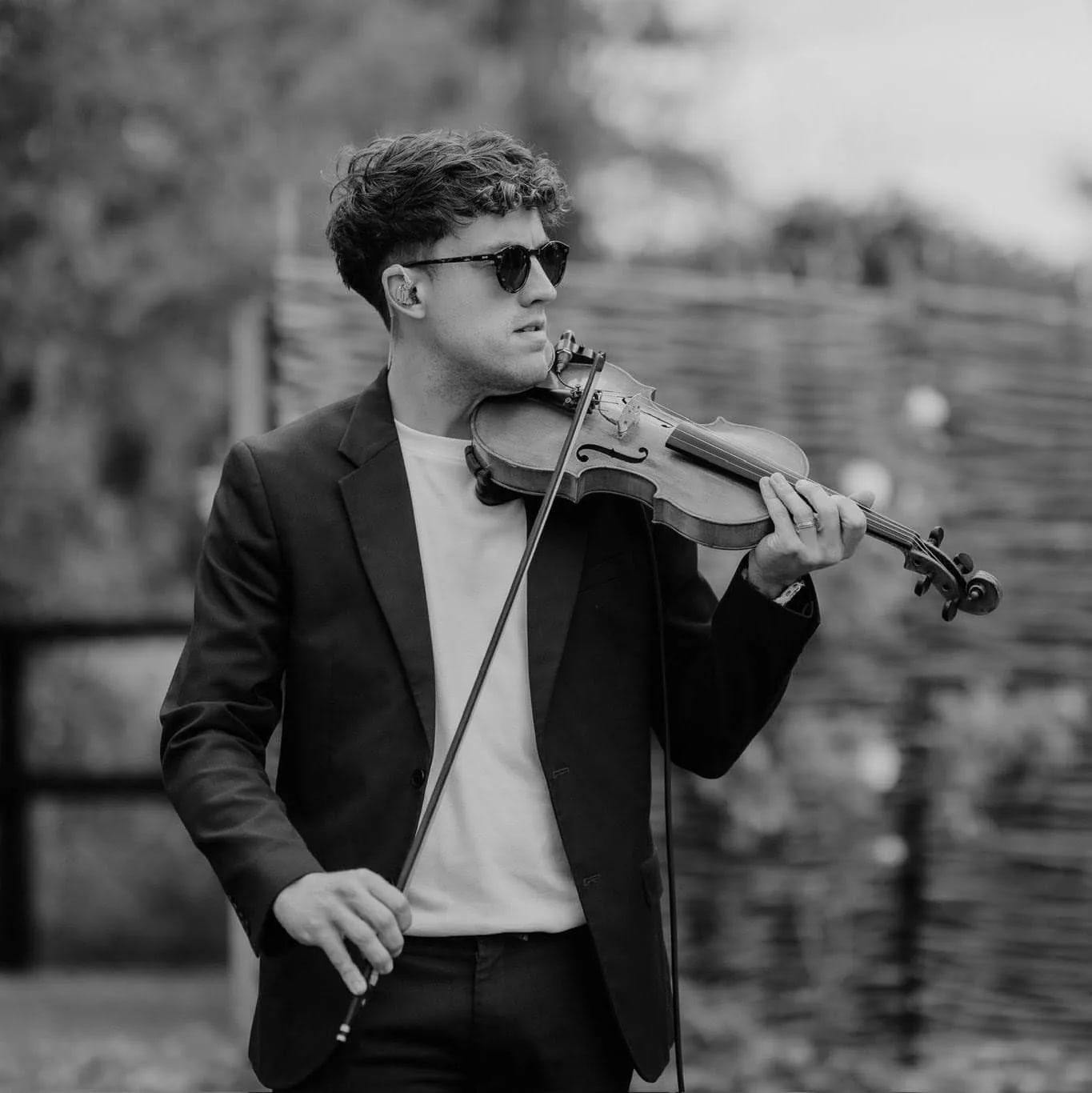 Joel Grainger standing with his violin