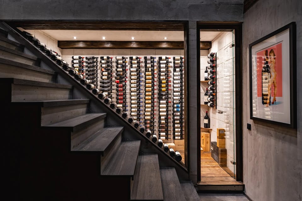 Staircase with wine cellar display in luxury Kitzbühel chalet