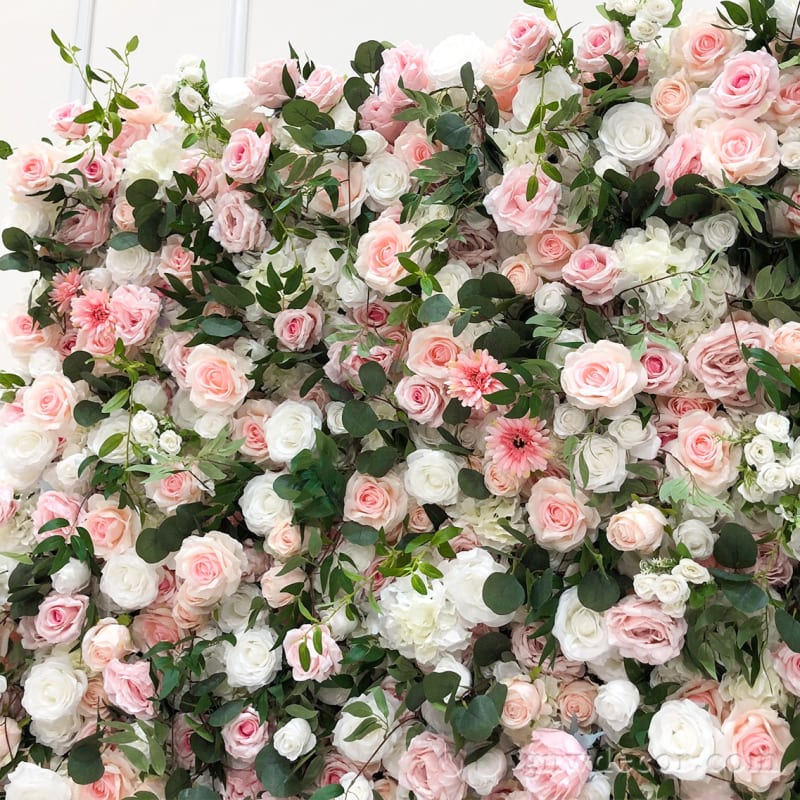 The image features a large pink and white flower arrangement, with a variety of pink and white flowers, including roses, in a vase.