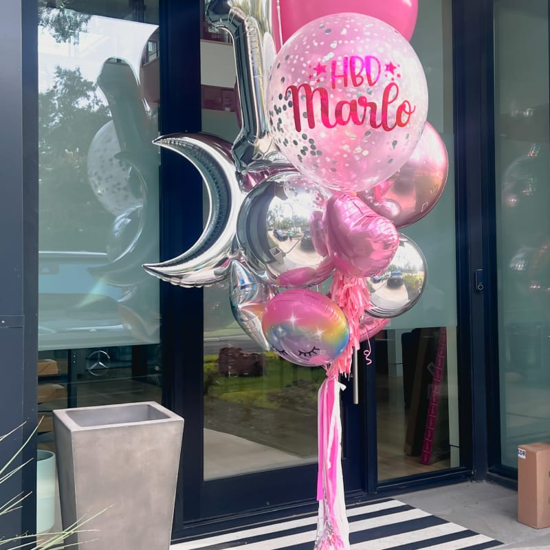 a bunch of balloons that are in front of a store front door with the words hello moon on it