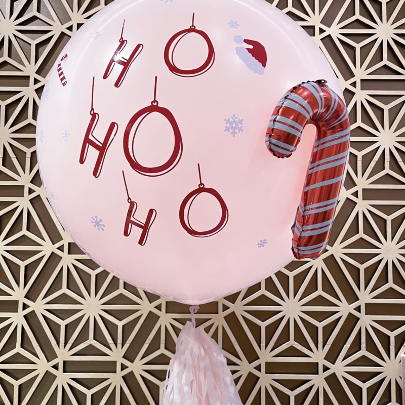 a balloon with the word oh oh on it hanging from a wall with a tasseled decoration on it