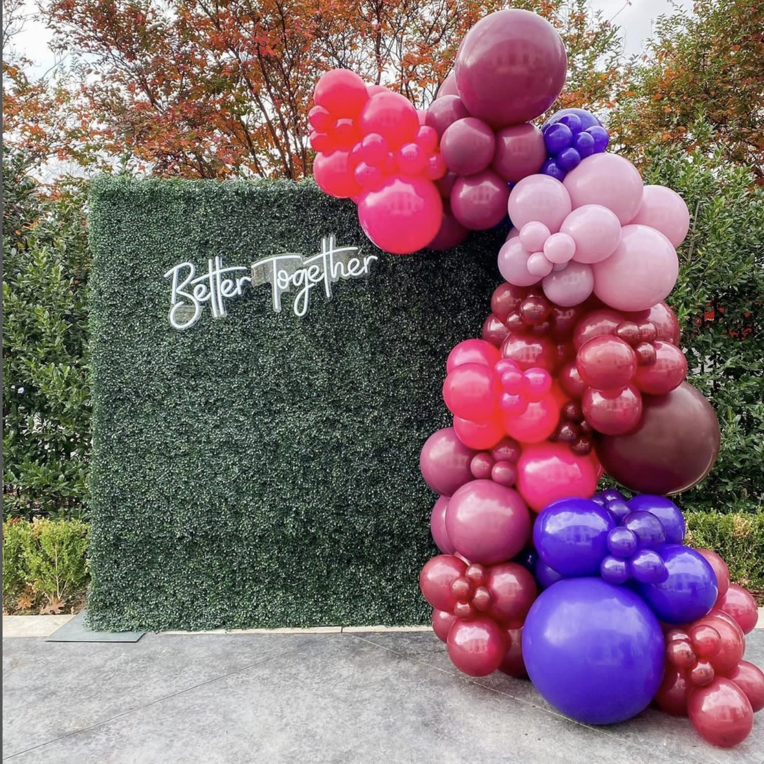 a bunch of balloons that are in the shape of a tower with a sign that says better together on it