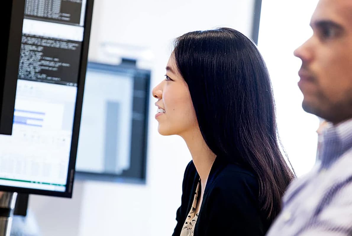 Photo of BAM Team members Review data on a computer