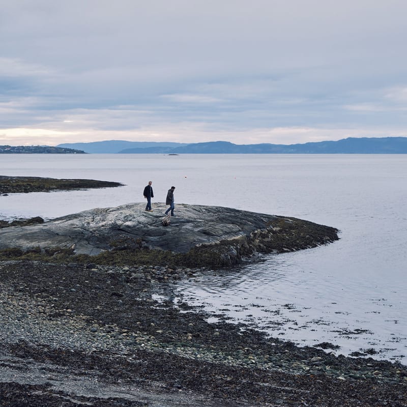 Two men walking on a rocky cliff