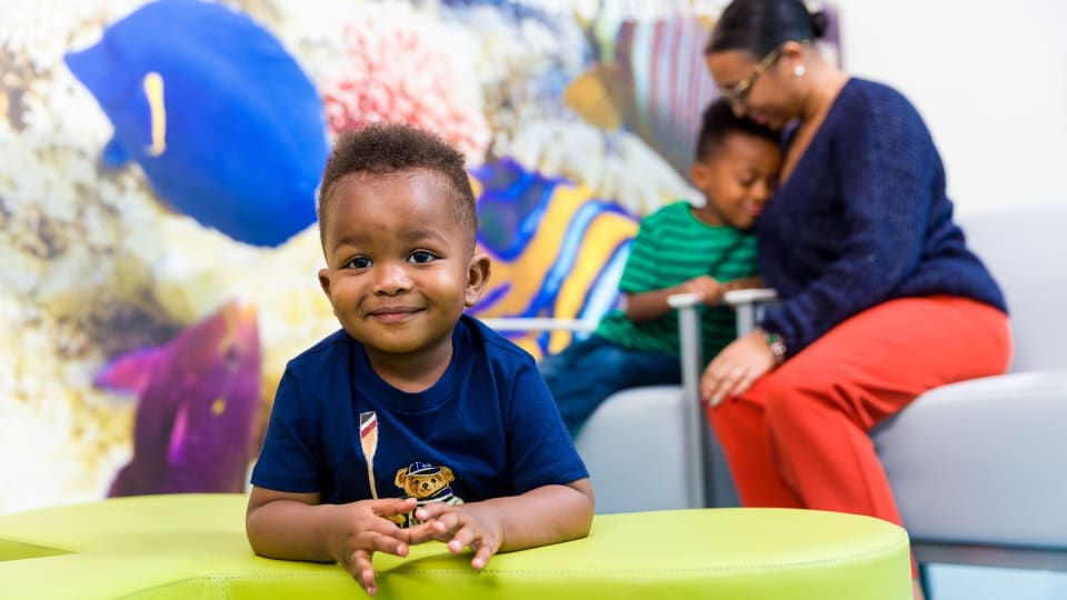 A mother and two children waiting in the ER reception area
